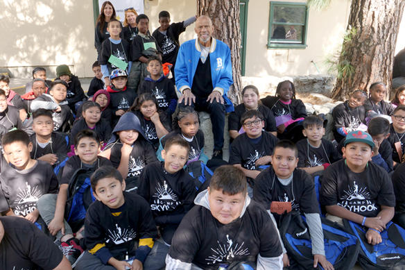 Basketball legend Kareem Abdul-Jabbar with students at Camp Skyhook, an immersive, outdoor learning experience that aims to initiate and encourage children’s interest in STEM